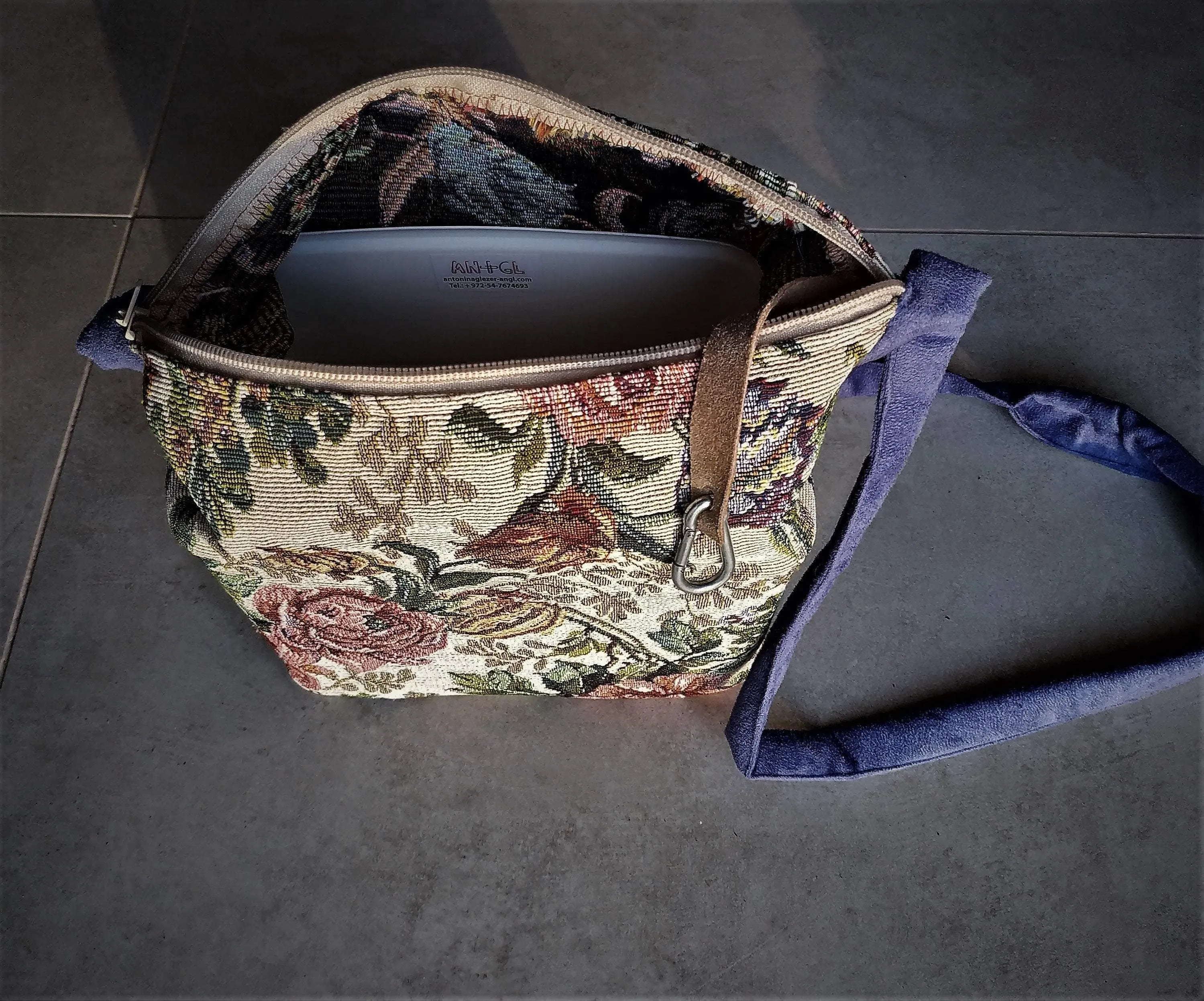 Bags made of tapestry with a long blue-gray handle and a zipper