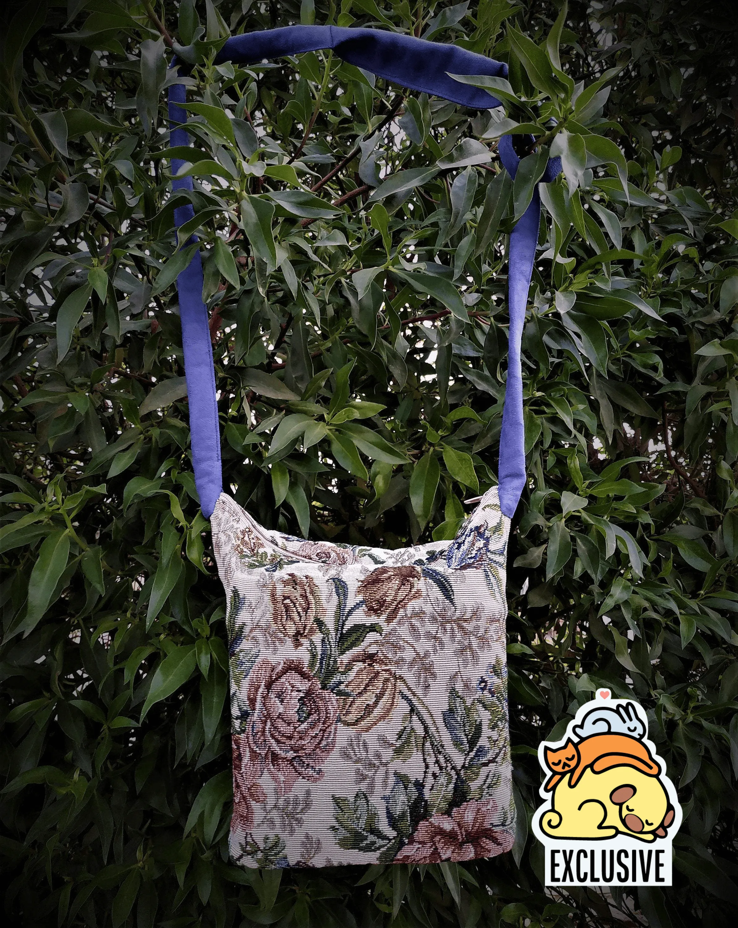 Bags made of tapestry with a long blue-gray handle and a zipper